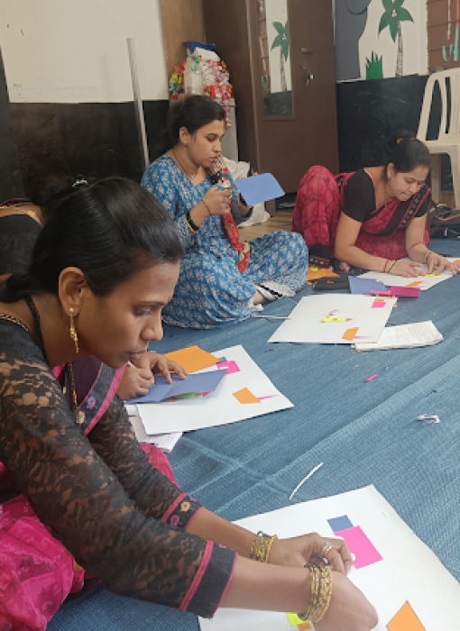 Women creating paper crafts and artwork, showcasing creativity and skill.